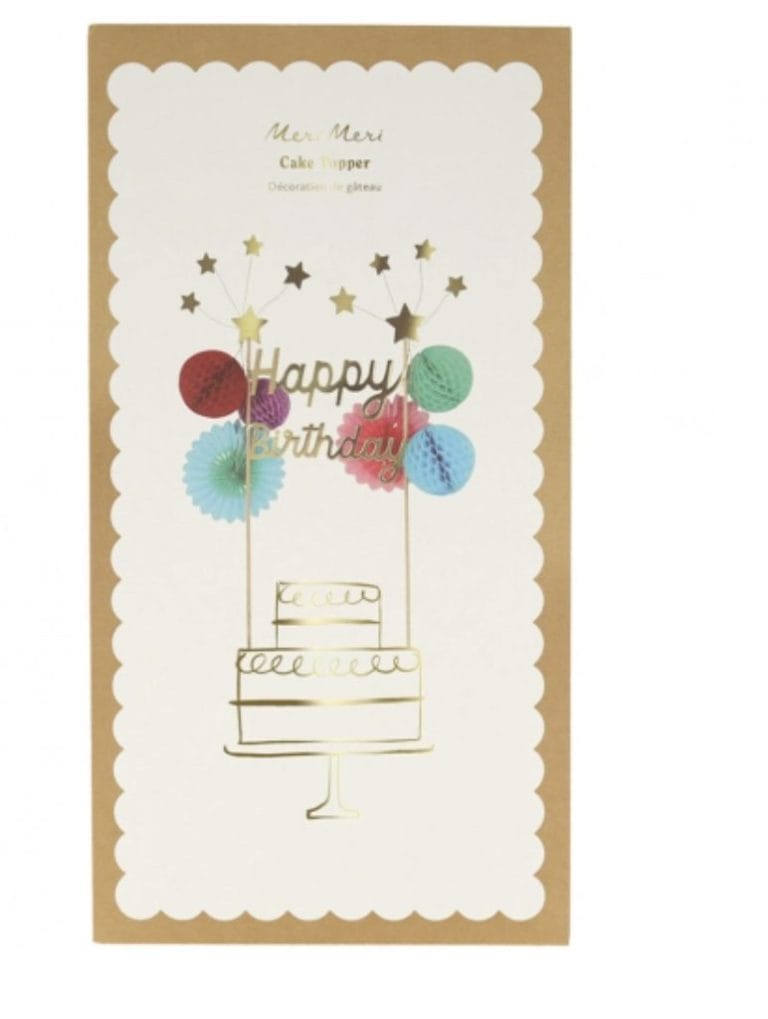 Meri Meri taarttopper in cadeauverpakking met twee goudkleurige stokjes, bloemen, sterren en de tekst Happy Birthday
