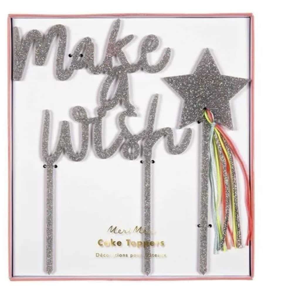 Taartversiering Make a Wish van Meri Meri in cadeauverpakking, met zilveren glitterletters, ster en kleurrijke linten.