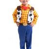 Jongen draagt een 4-delig cowboy set met geel-rood geruit overhemd, koeienvlekkenvest, rode halsdoek en blauwe broek.