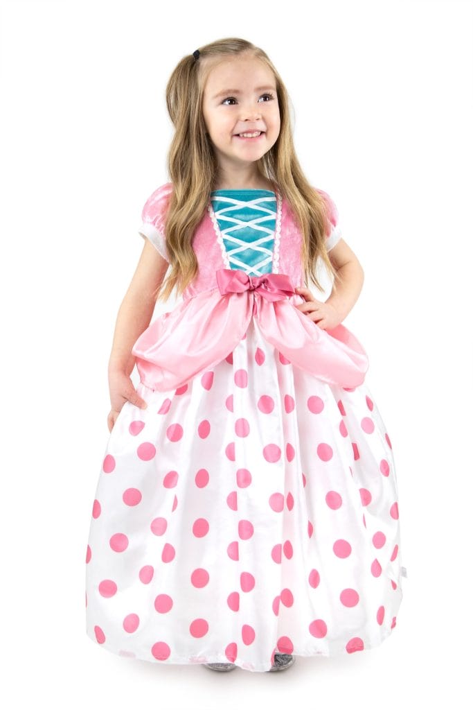 Meisje draagt een roze Bo Peep kostuum van Little Adventures met witte rok met roze stippen en grote strik