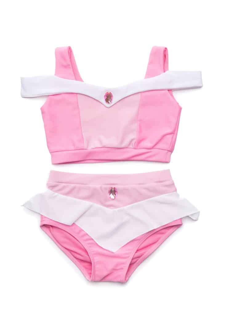 Roze Doornroosje zwempakje in bikini-stijl, plat gelegd met witte bandjes, volantrokje en glanzende details